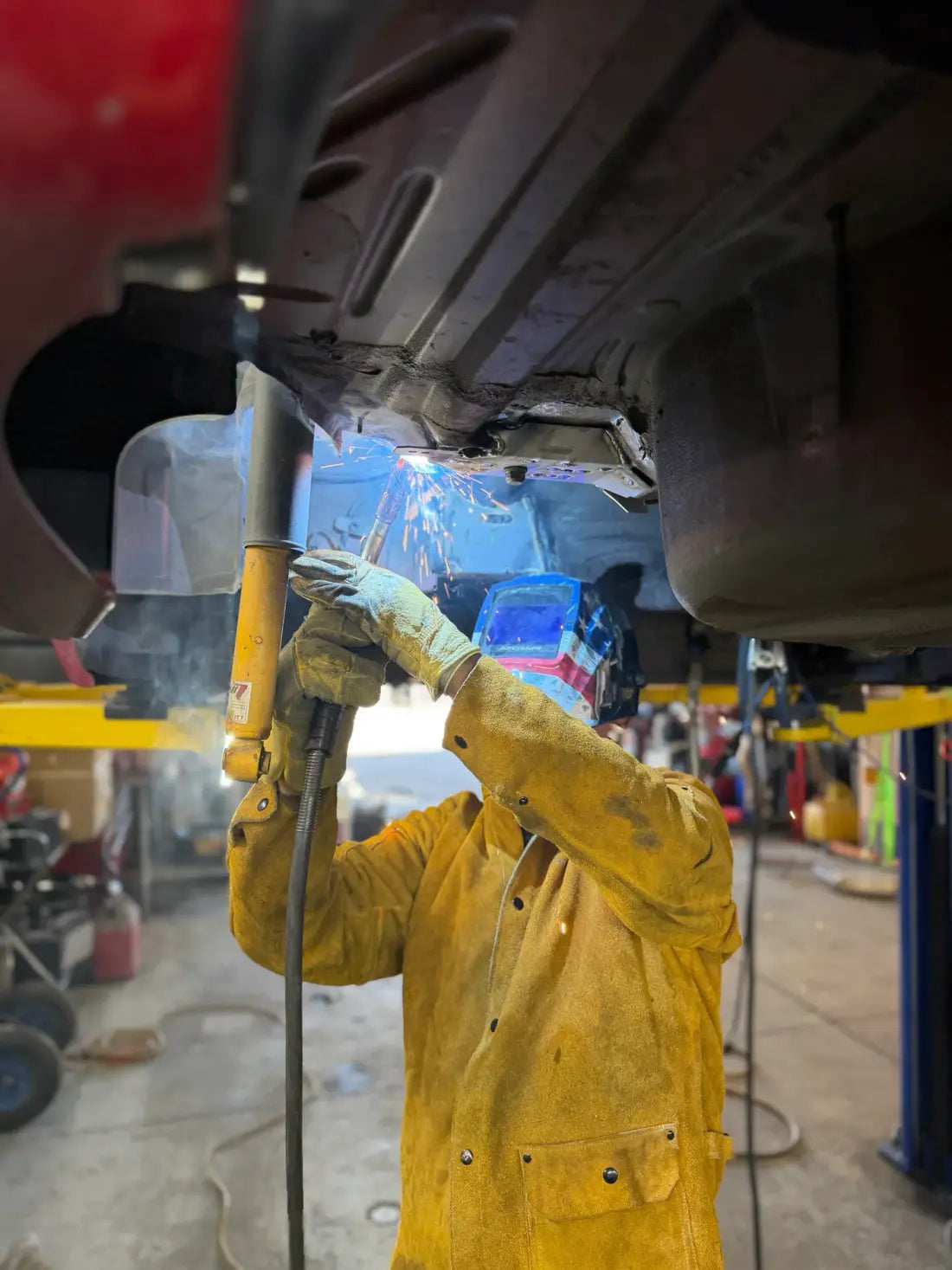 AYRD technician welding beneath a vehicle